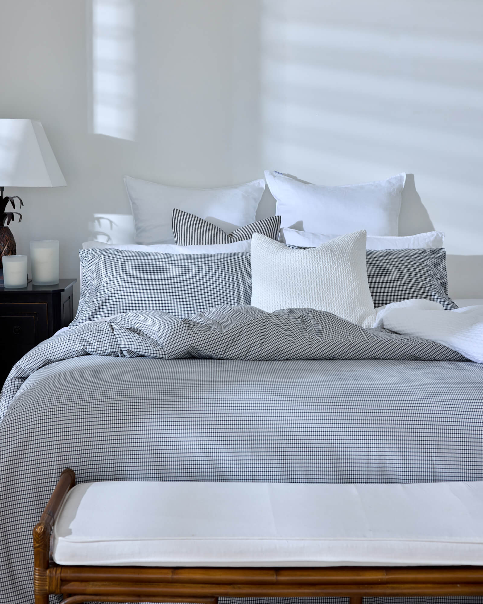 Royal Doulton Kent duvet cover styled on a bed with coordinating Wade duvet cover set, Winslow Snow Cushion, Montrose Stripe Cushion, Beaumont Check Cushion.