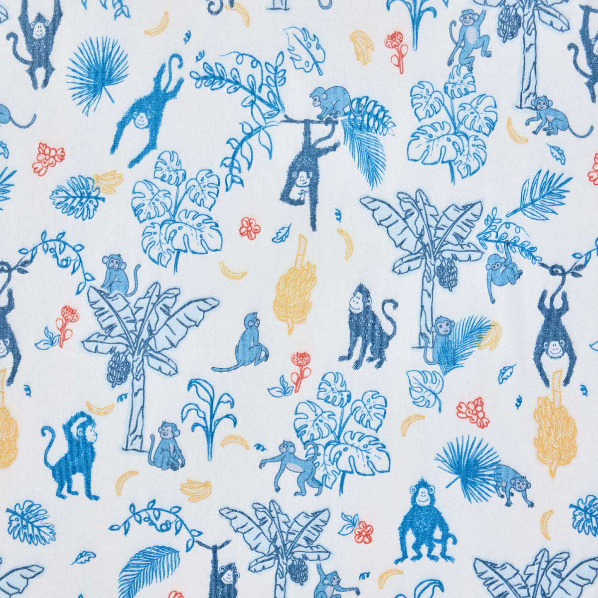 Blue monkeys climbing tropical leaves and branches on cream Twill & Co nursery fabric