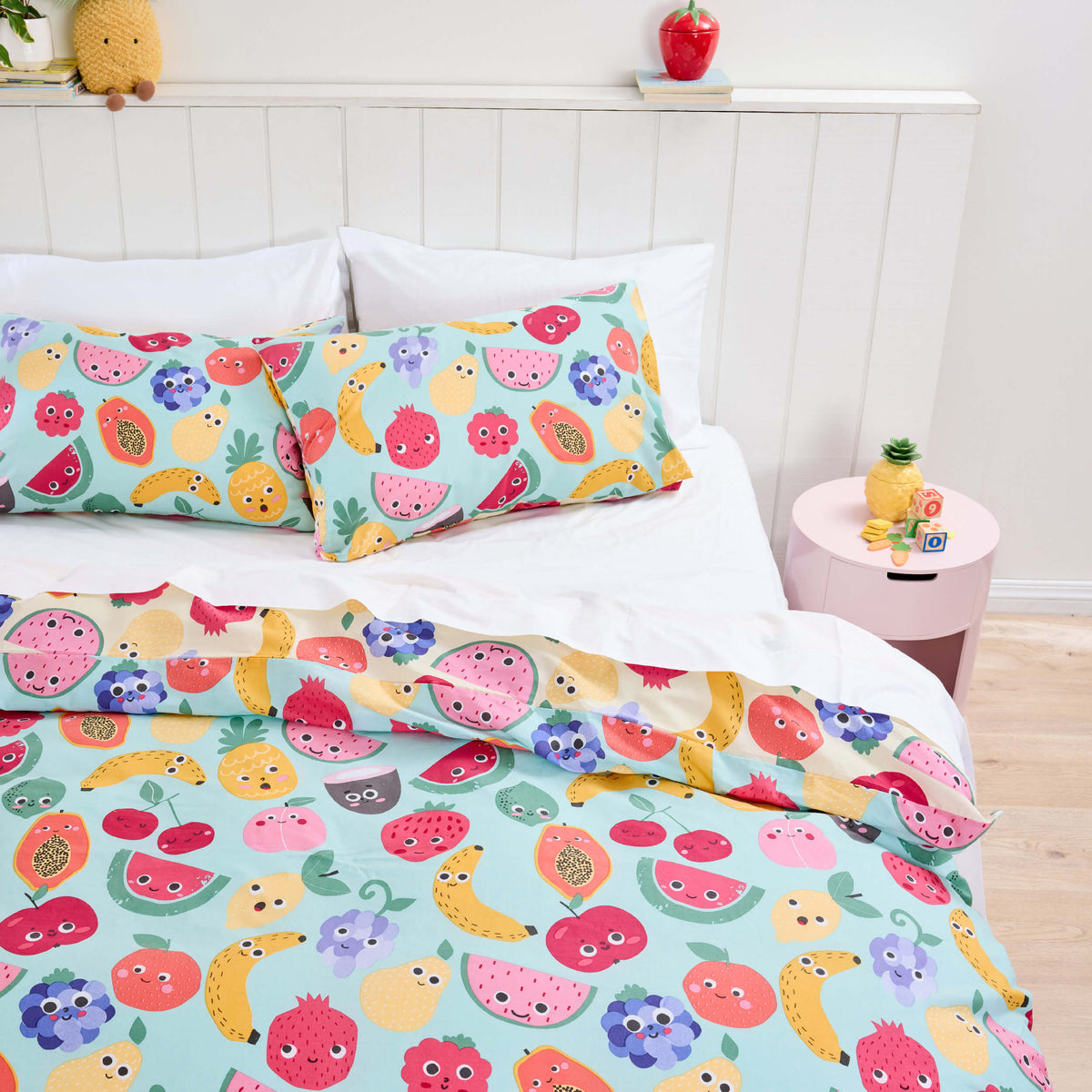Smiling fruit illustrations on a mint-green Twill & Co kids duvet cover and pillowcases