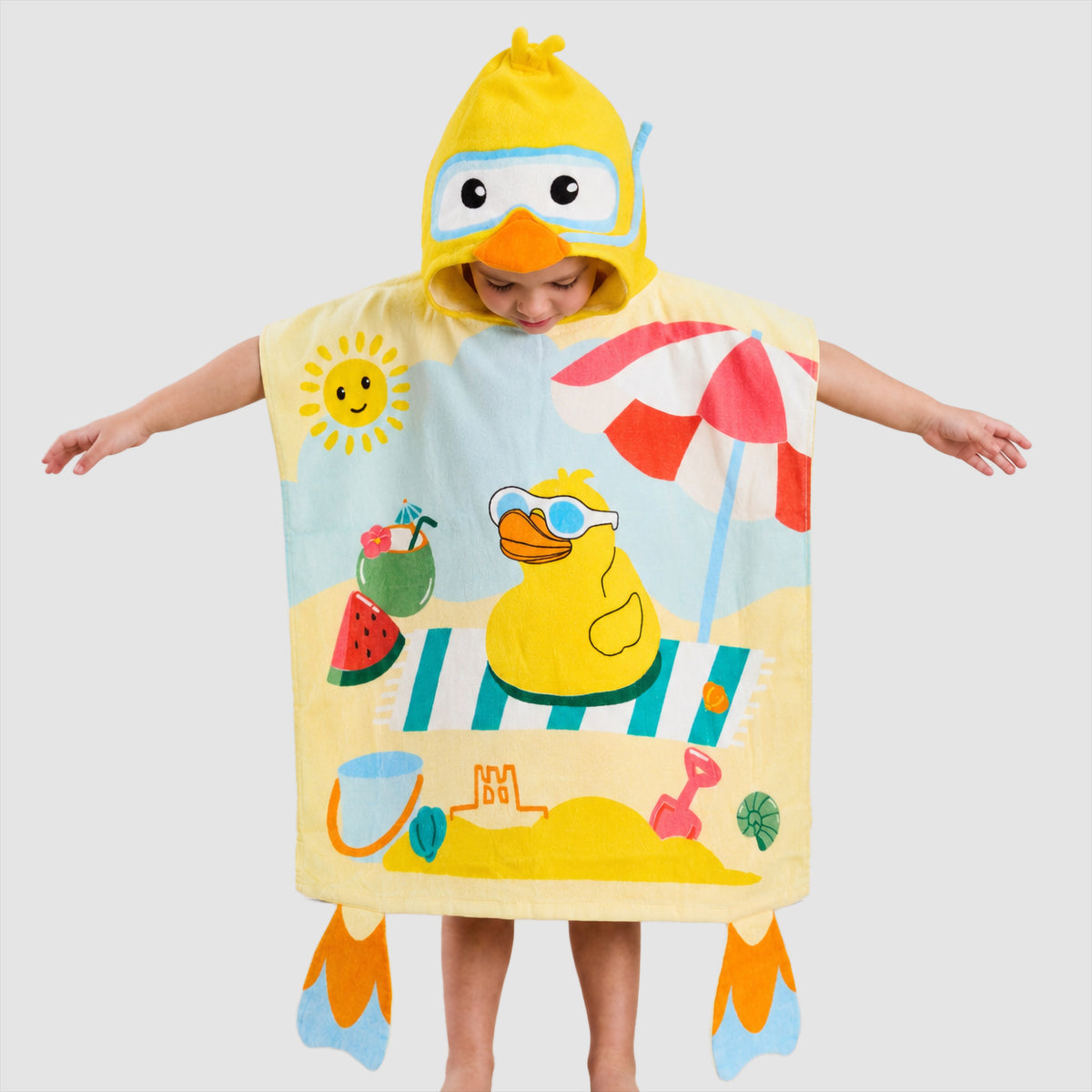 Child wearing a yellow Twill & Co duck hooded beach towel with a duck and beach umbrella design