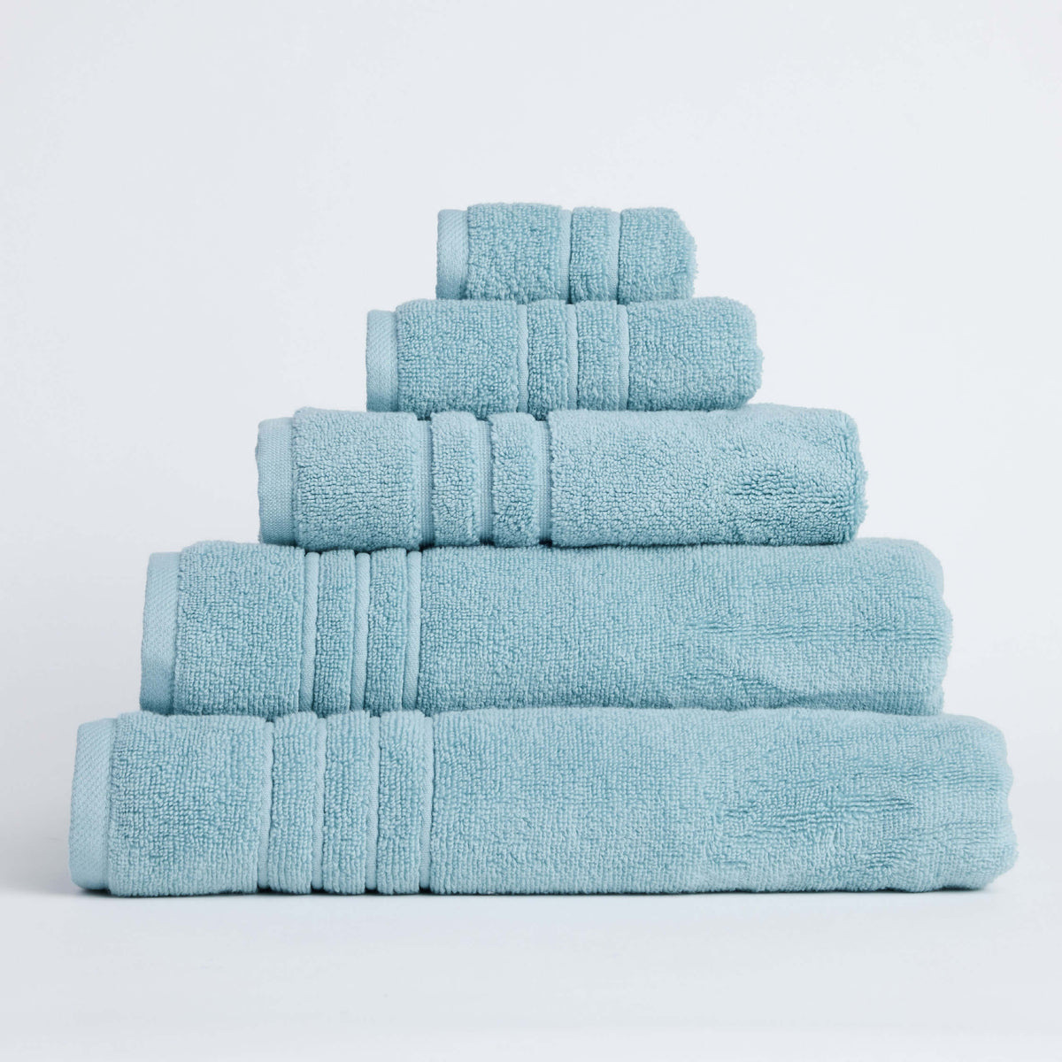 Twill & Co Sora Seafoam towels stacked against a pale background with their aqua borders aligned