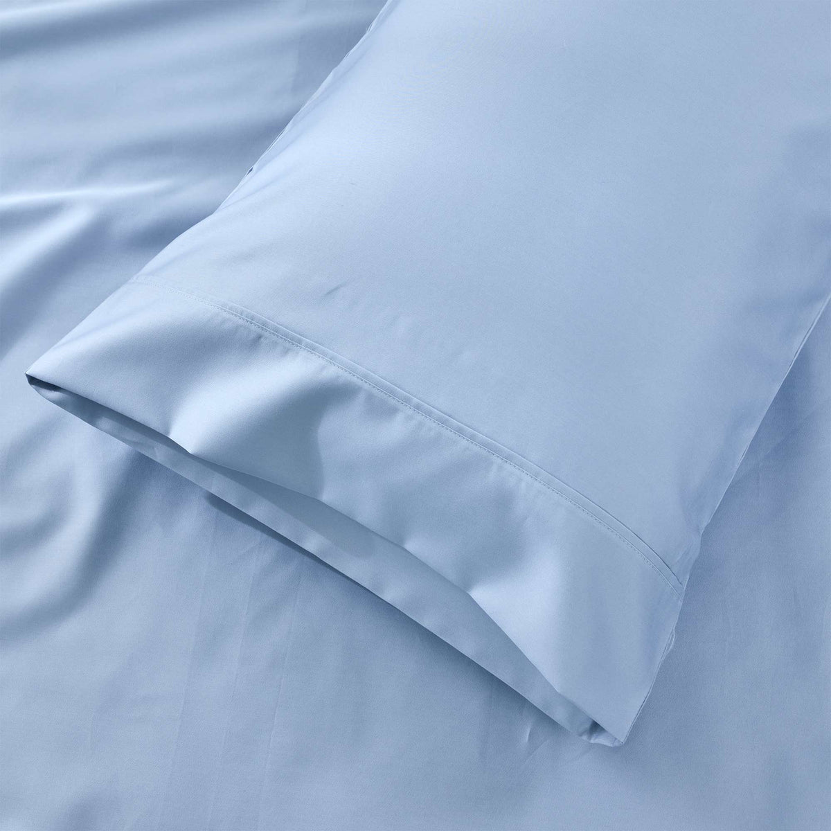 Royal Doulton Sola Sky pillowcase resting on matching sheets