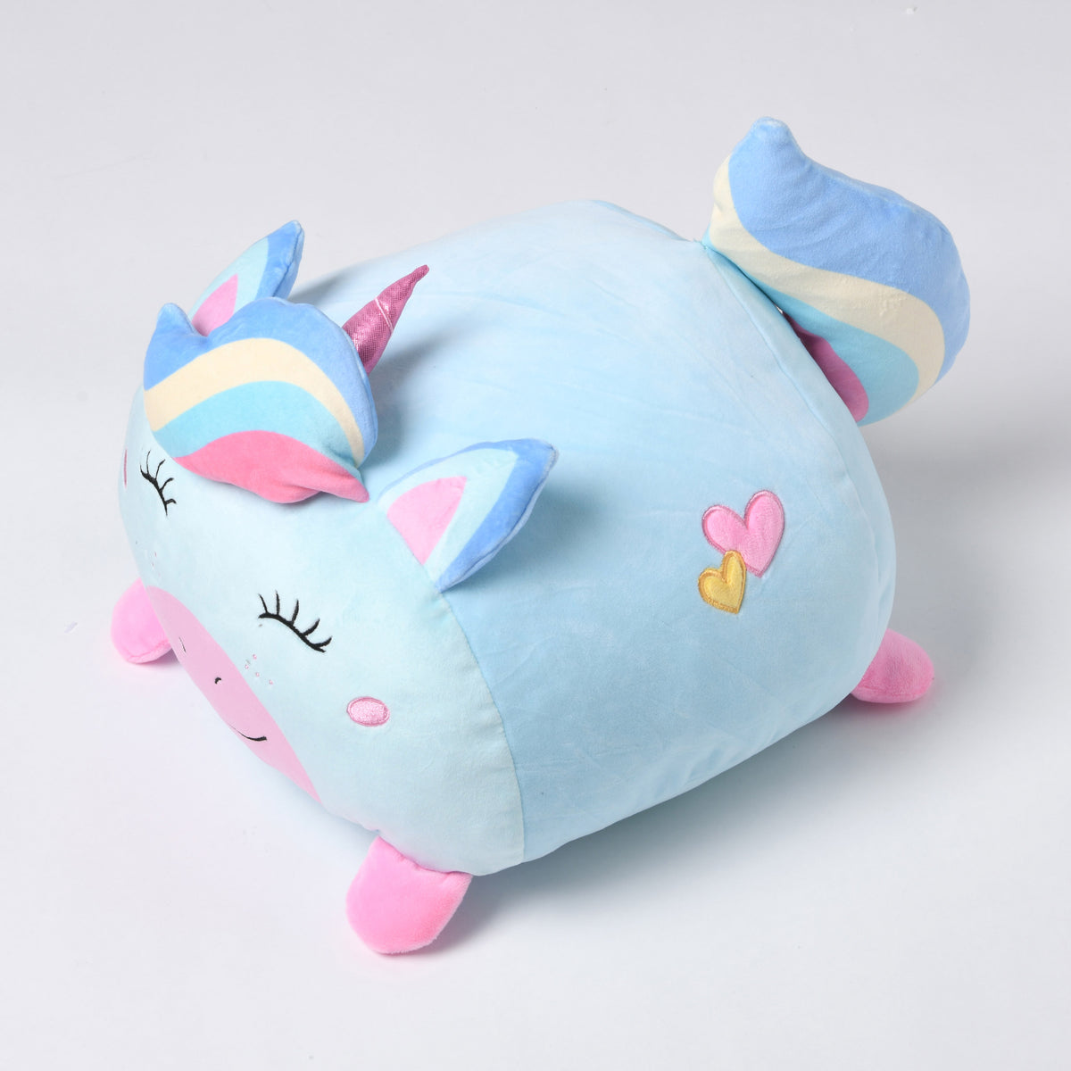 Pale blue Twill & Co unicorn cushion with a striped mane and tail, pink feet and heart details