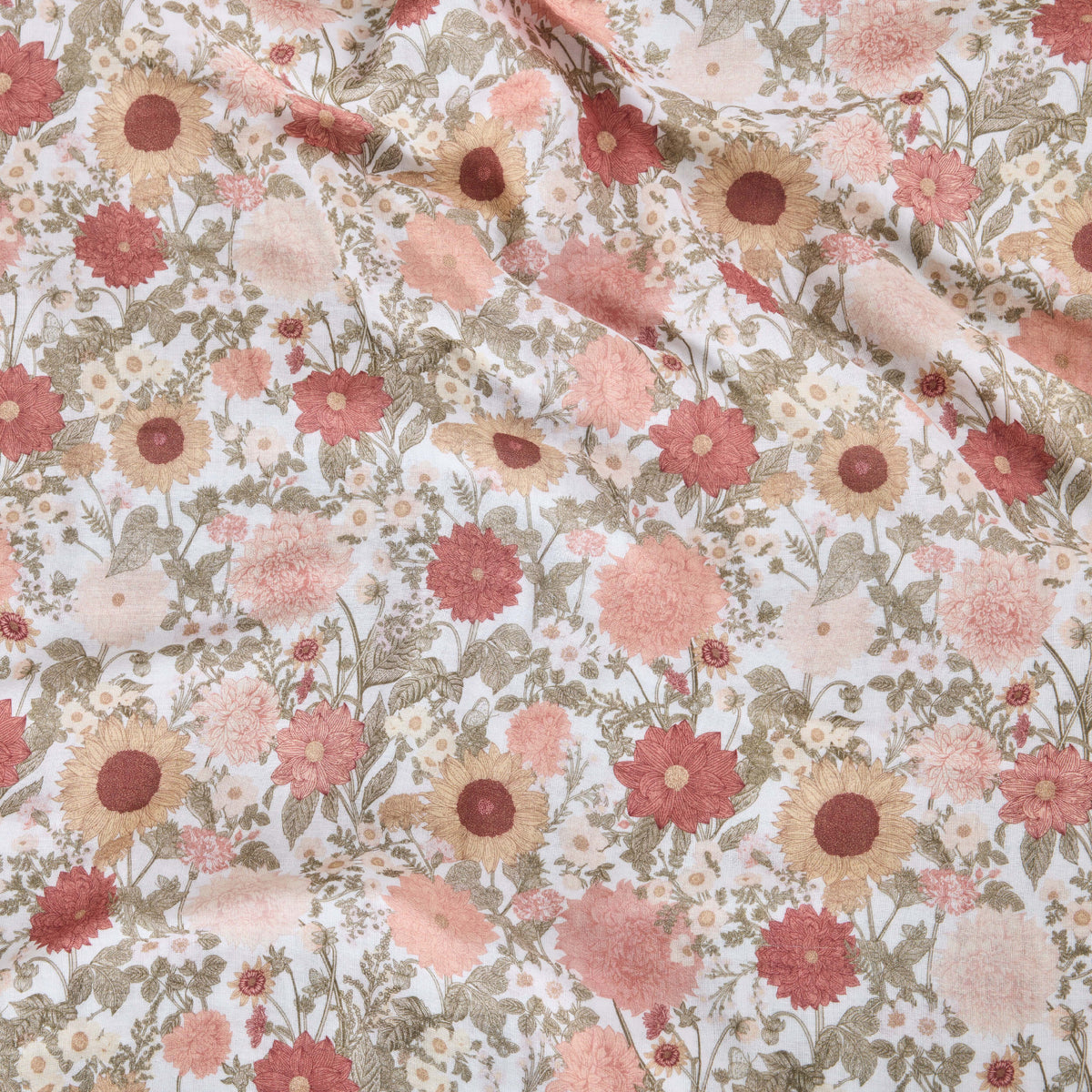 Twill & Co nursery fabric with pink and rust flowers and green leaves on a pale background