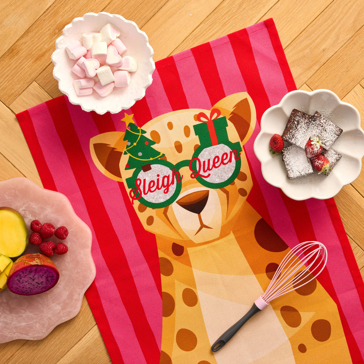 Pink-and-red striped Twill & Co Christmas tea towel with a leopard wearing Sleigh Queen sunglasses