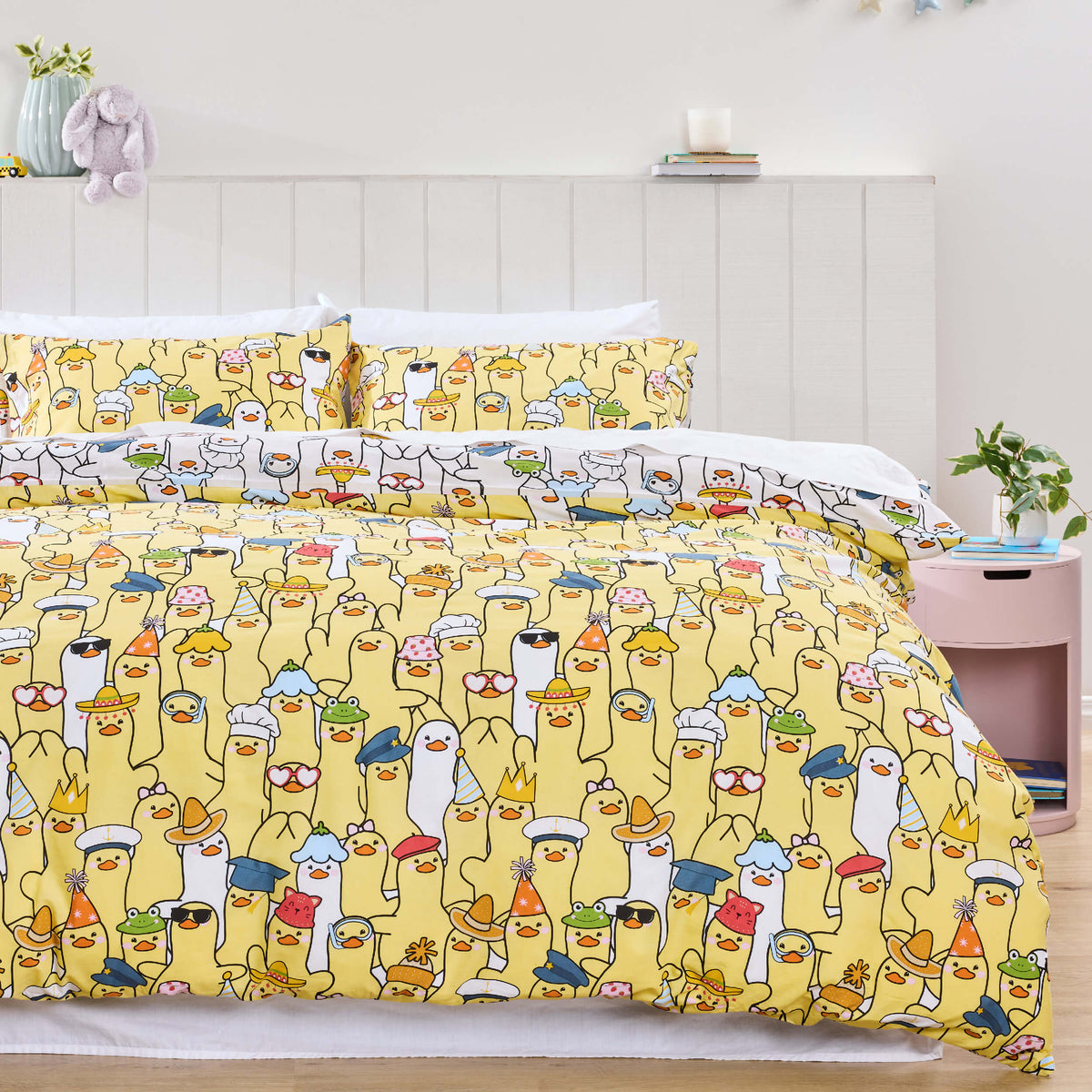 Twill & Co Duckies bedding with rows of illustrated ducks on a yellow background