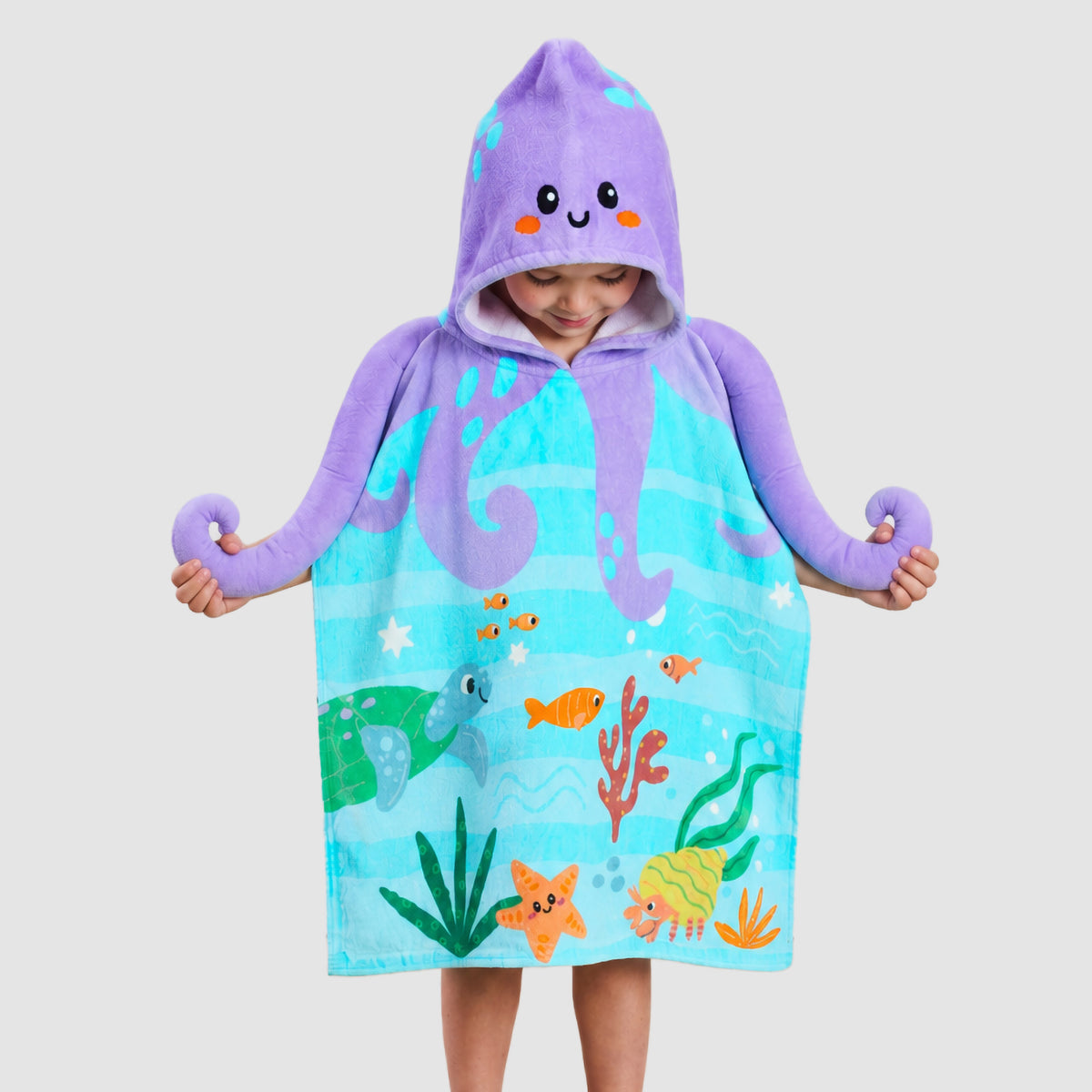 Child wearing a turquoise Twill & Co sea-life towel with a purple octopus hood and tentacles
