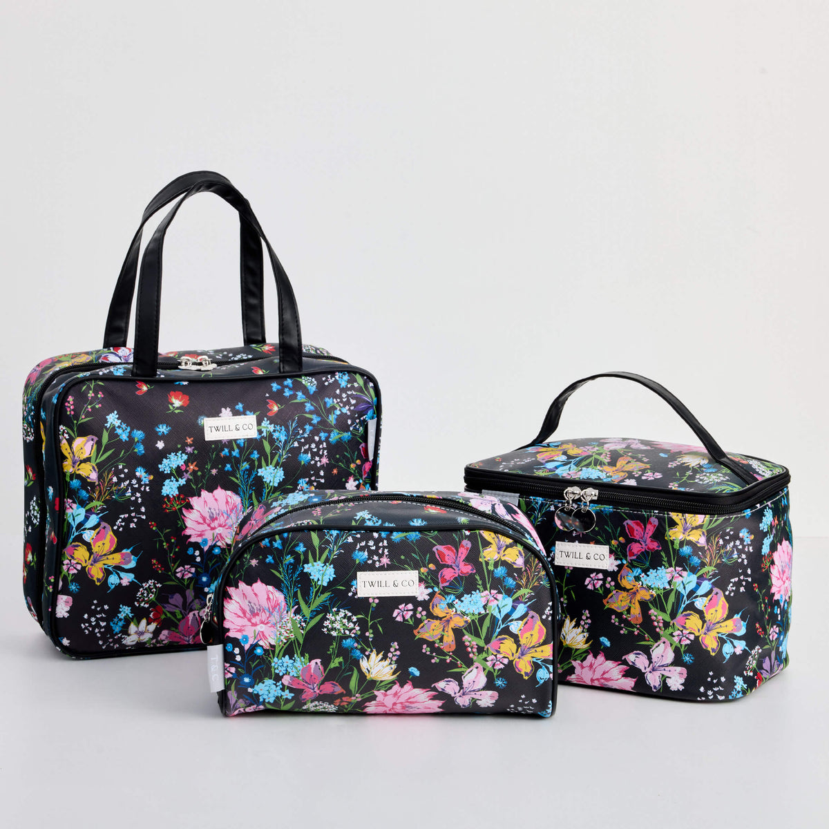Twill & Co Liberty Black floral toiletry bags grouped with a pouch and handled cases