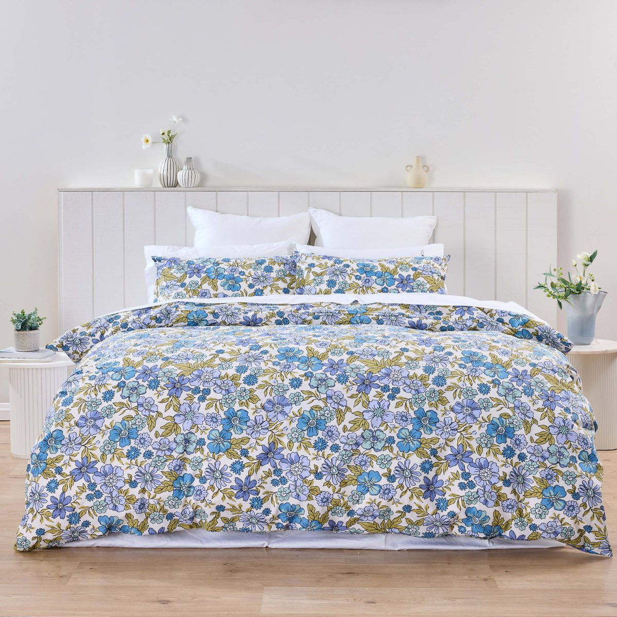 Blue, green and yellow flowers cover a Twill & Co Violet duvet set in a bright white bedroom