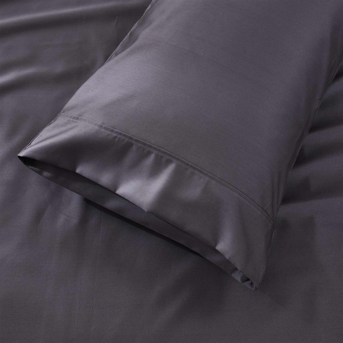 Royal Doulton Sola Charcoal pillowcase resting on matching sheets