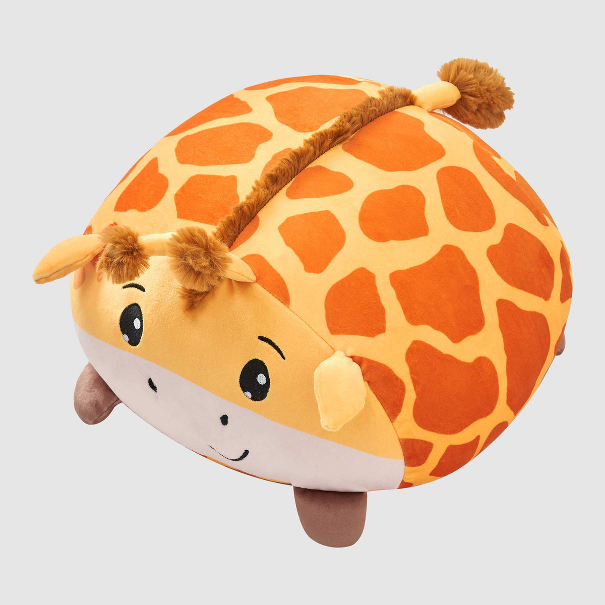 Round orange and yellow Twill & Co giraffe cushion with ears, a mane and small legs