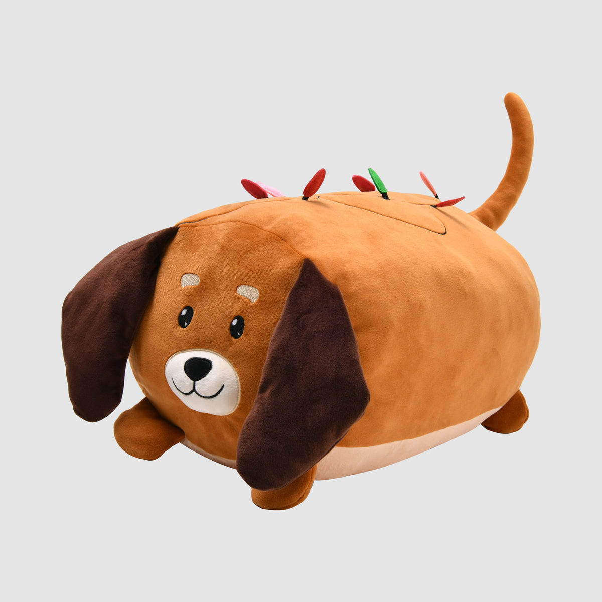 Brown Twill & Co Christmas dog cushion with floppy ears and colourful decorations along its back